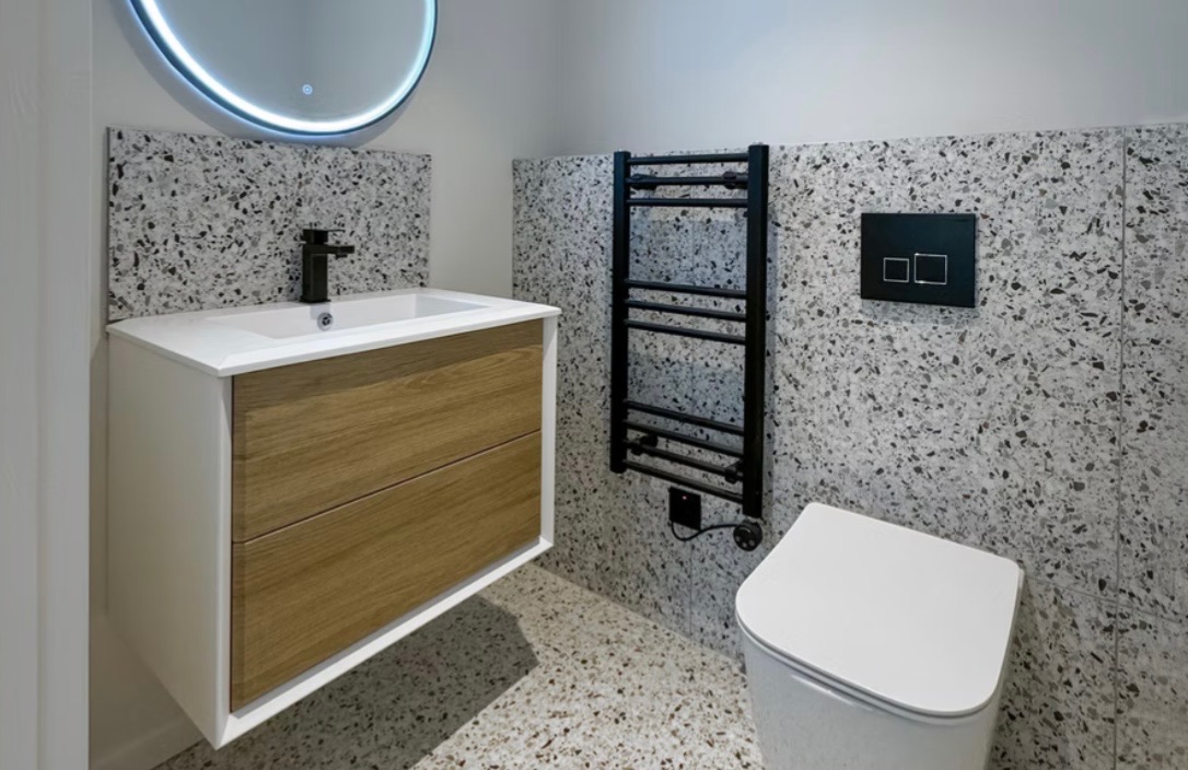 Modern bathroom renovation by HHB Contractors in Liverpool featuring terrazzo tiles and floating vanity