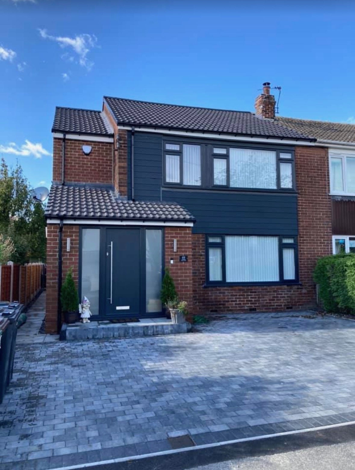 Exterior property refurbishment in Liverpool with dark cladding and block paving by HHB Contractors